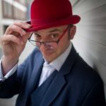 a picture of the magican Danny Jurmann aka Red Hat Magic in his trademark red bowler hat