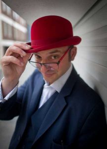 a picture of the magican Danny Jurmann aka Red Hat Magic in his trademark red bowler hat