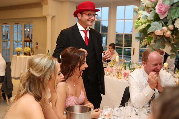 Wedding guests laughing with the Surrey wedding magician