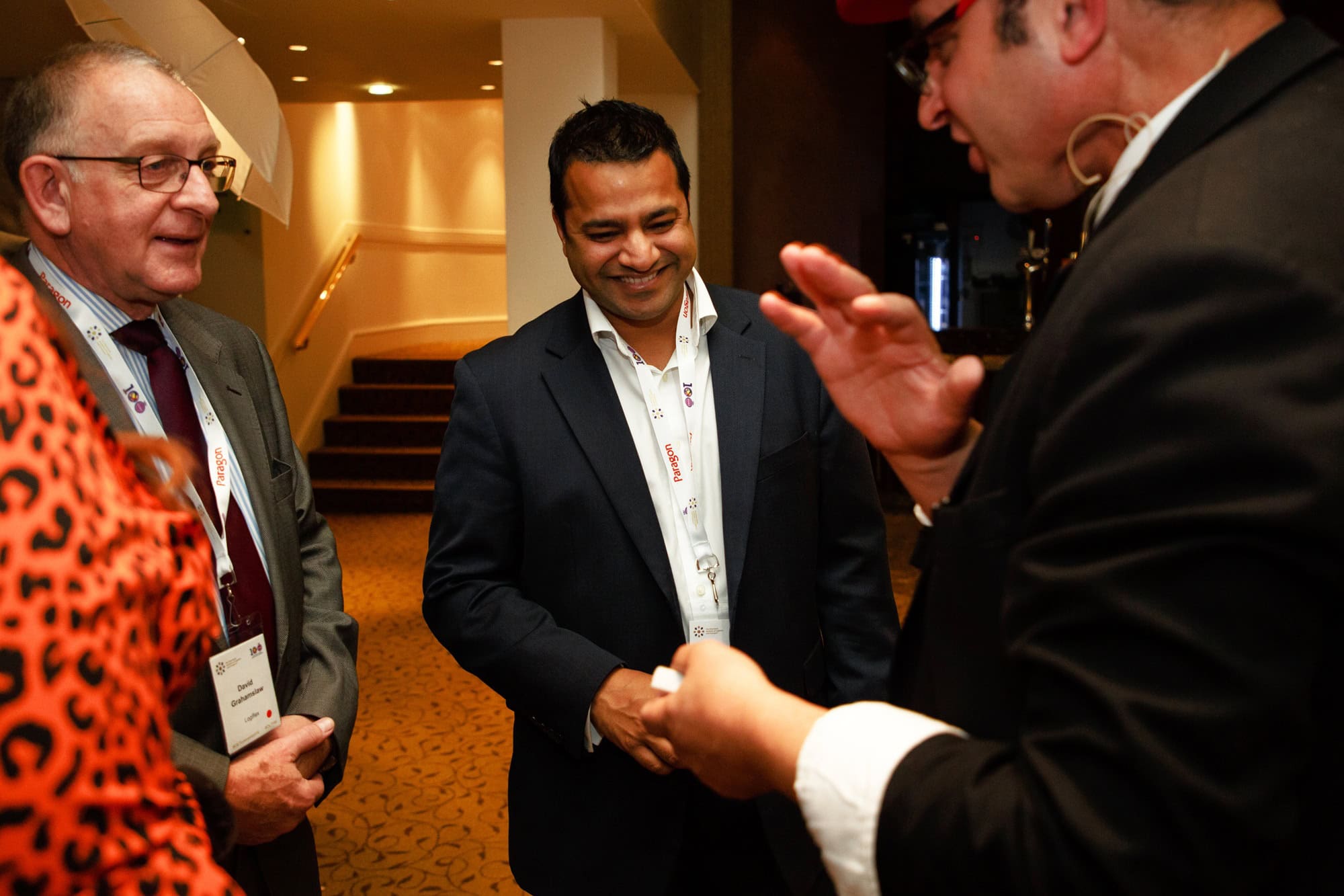 2 gentlemen enjoying close up magic at a corporate event - The Chartered Institute of Logistics and Transport annual get together in London.