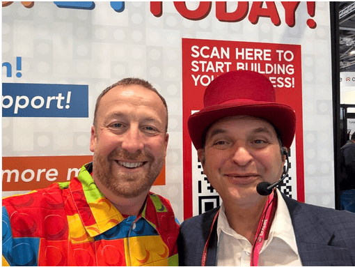 Simon Chaplin with trade show magician Red Hat Magic